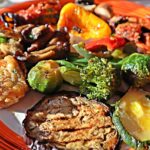 Verdure grigliate arricchite con semi di sesamo, ideali per ridurre il gonfiore estivo.